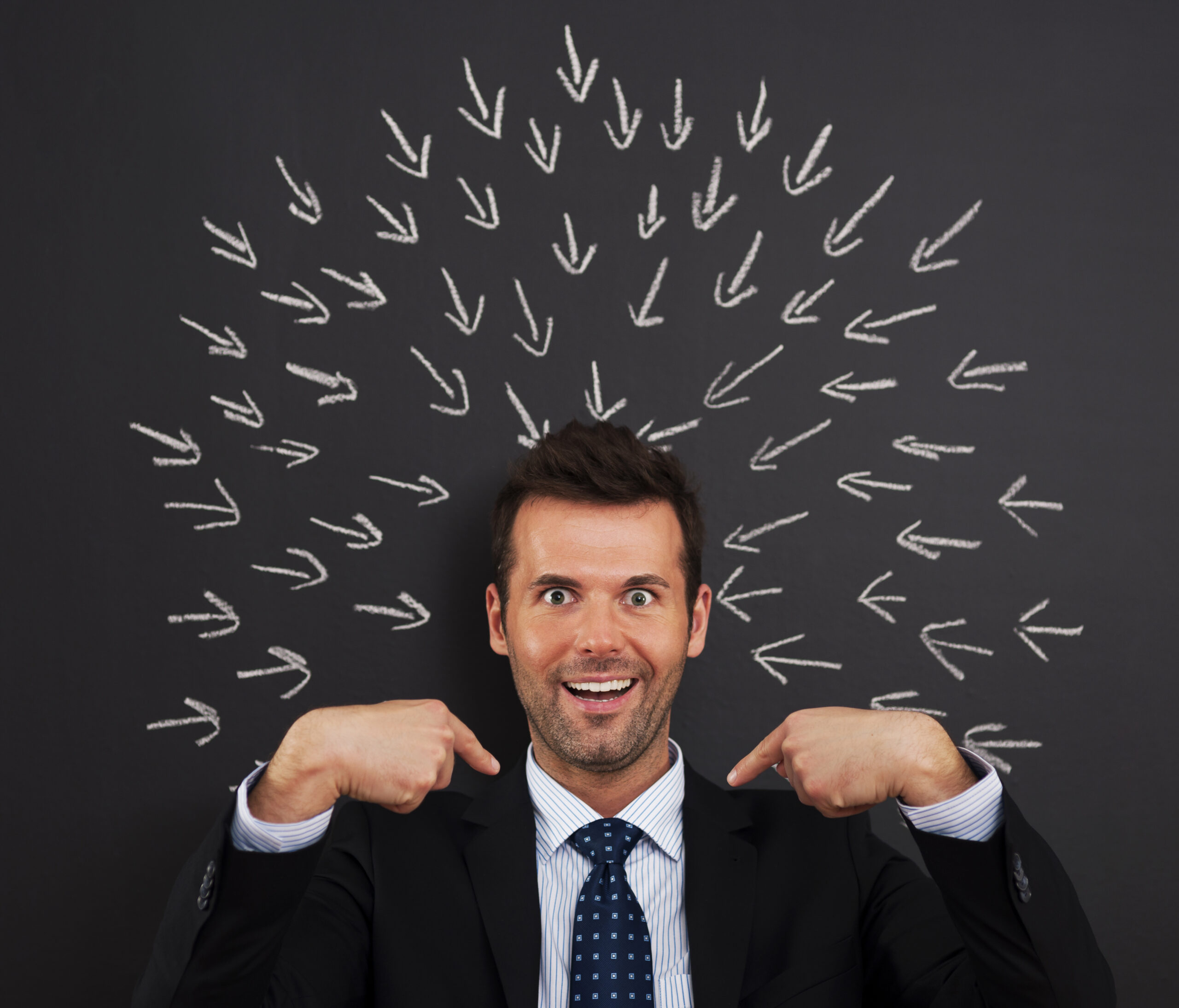 a man pointing at his head with arrows pointing at his head